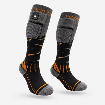 Pair of Heat Up Junior heated socks, grey and black with orange accents and cuff battery pocket, on white background