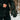 Person zipping a jacket in the snow while wearing a Heat Up Mountain heated mitten