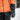 Child in an orange winter jacket wearing a Heat Up Junior heated mitten