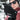 Person wearing black 'HEAT UP' gloves with a blurred outdoor background