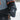 Child in a snowsuit wearing a Heat Up Junior heated mitten, heat button lit