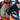 Backcountry skier holding snowy skis while wearing Heat Up Mountain heated mittens